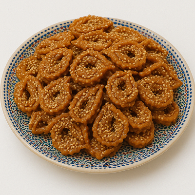A plate of traditional Moroccan Chebakia pastries sprinkled with sesame seeds – How to Make Moroccan Chebakia