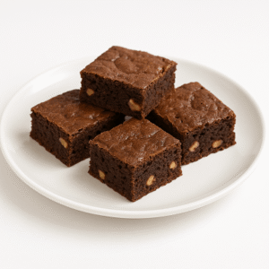 A close-up of Moroccan walnut brownies arranged on a white plate over a clean white background.