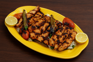 Lemon garlic chicken skewers sizzling on a grill with golden edges and fresh herbs