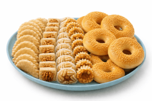 What makes homemade bagels soft and chewy – Blue plate with sesame bagels and traditional pastries on white background