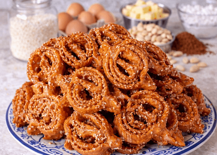 Moroccan chebakia pastries served with baking ingredients in the background